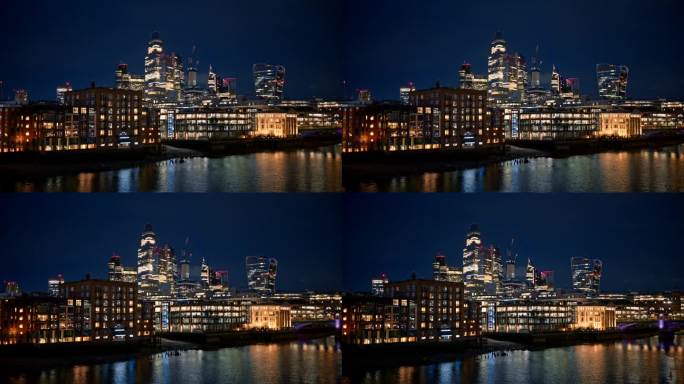 伦敦市中心的夜景，英国。在市区的摩天大楼和其他建筑物，泰晤士河，大量的照明