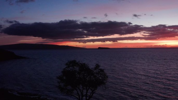 低空平移航拍，在夏威夷毛伊岛，远处的Kaho'olawe和Molokini火山口映衬着天空。4K