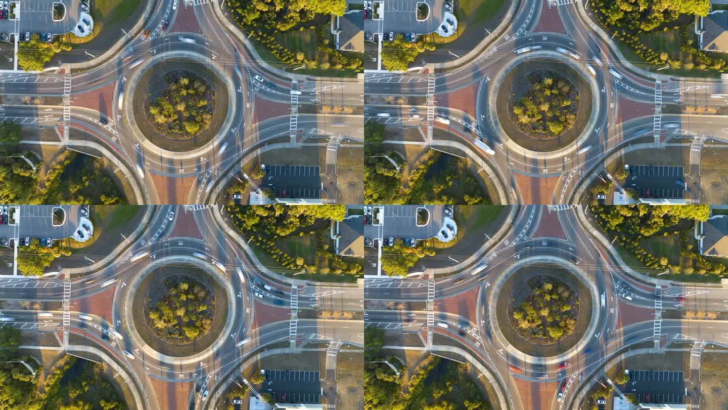 城市街道交通的俯视图在环形交叉路口与快速移动的汽车。城市循环交通十字路口的时间间隔