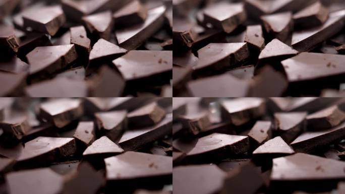 碎黑巧克力碎片靠近。香甜可口的可可原料。旋转