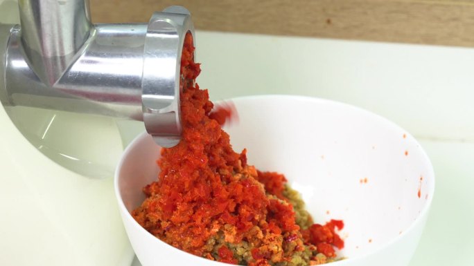 用绞肉机磨红辣椒。