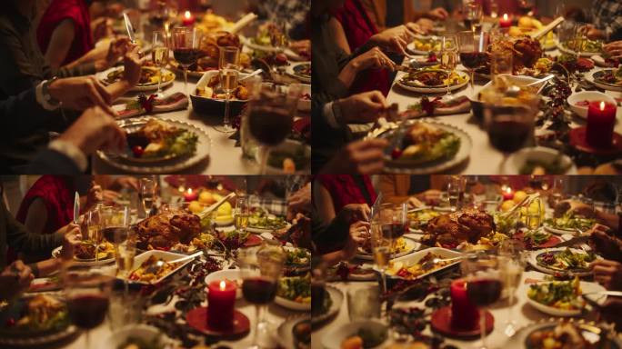 近距离拍摄一个成年人的手享受节日大餐，切火鸡肉在盘子里。一个不知名的男人和一群不同的亲戚朋友坐在餐桌