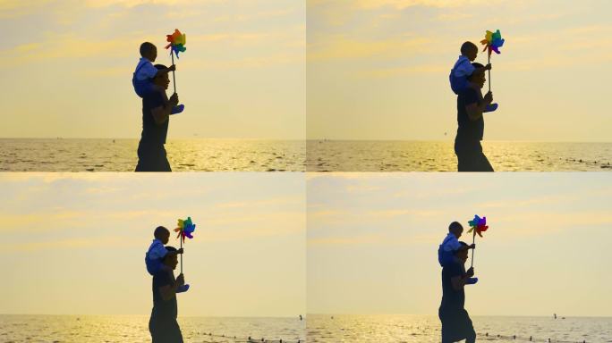 父子情-爸爸扛着儿子在海边散步父亲节亲子