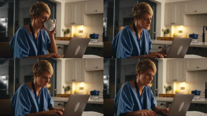 穿着医疗服的疲惫女人晚上在家里用笔记本电脑工作或学习，喝着热饮