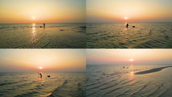 意境赶海清晨日出赶海的人一个人走在海面上