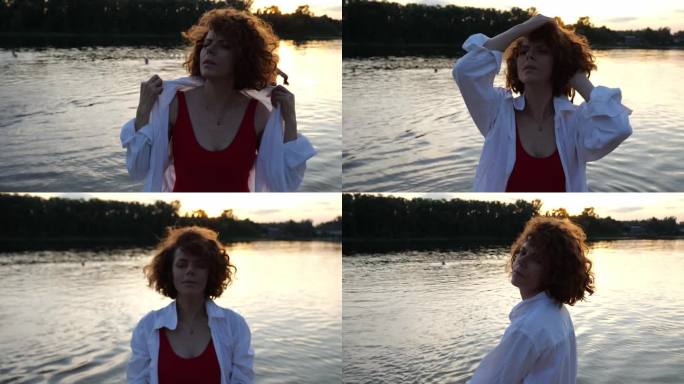 一个30岁的红头发女人的肖像，穿着白衬衫和泳衣，在河边，背景是男人。慢动作沙滩肖像