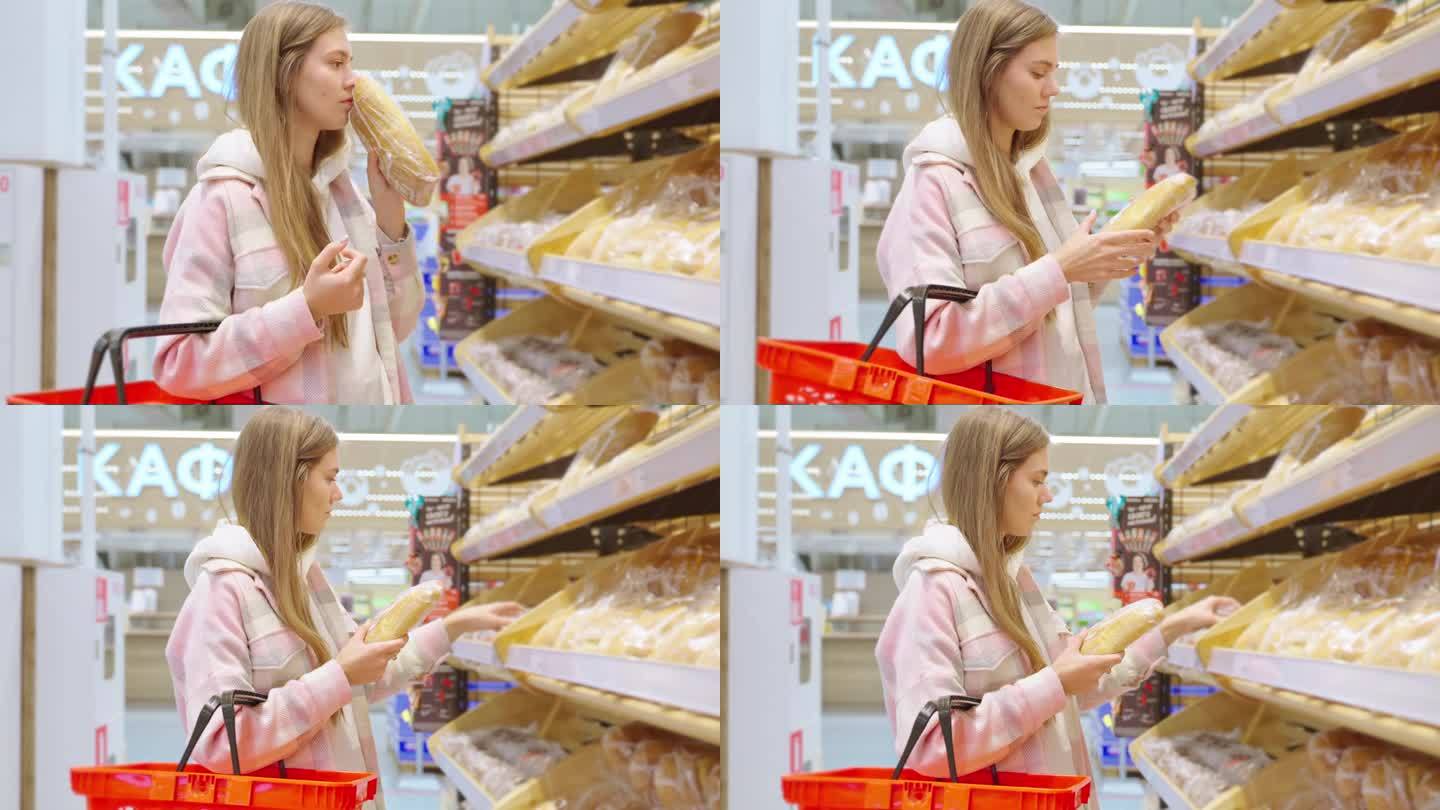 金发女郎在超市买新鲜的小麦面包，闻着面包的香味。