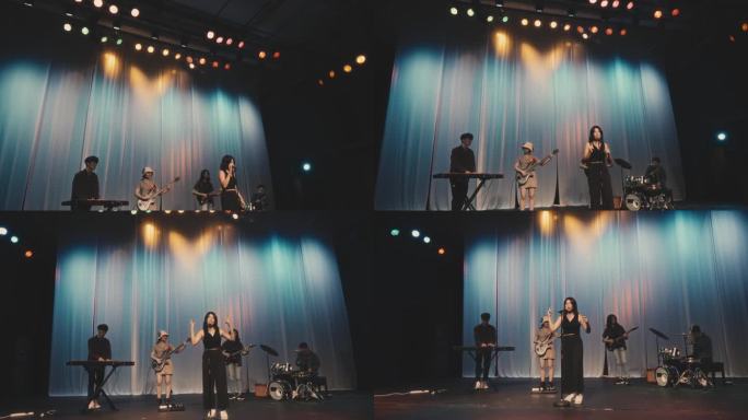 中国流行女歌手与多民族乐队在舞台上现场表演