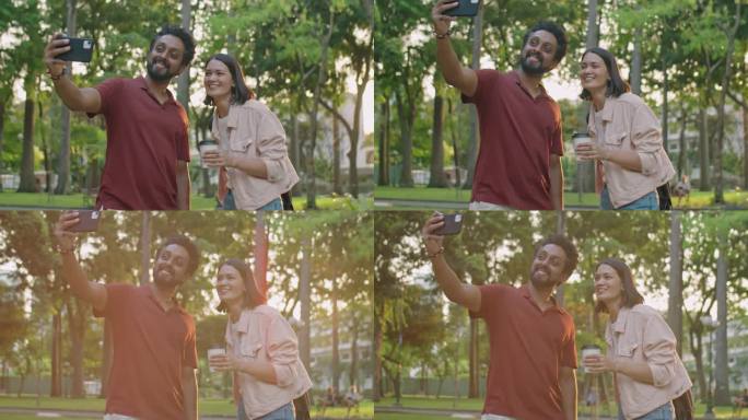 开心的朋友在公园用智能手机自拍