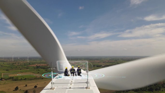 组三名工程师在某风力机顶部检查风力机工况并绘制风力机图纸。