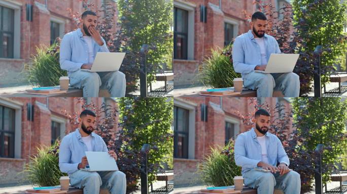英俊的阿拉伯人坐在木凳上，拿着咖啡和书，在现代无线笔记本电脑上工作。穿着随意的年轻男性感觉疲惫，偏航