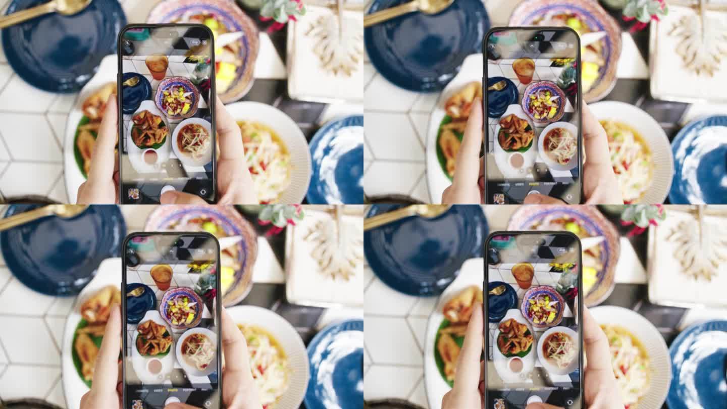 女性用现代智能手机给食物拍照