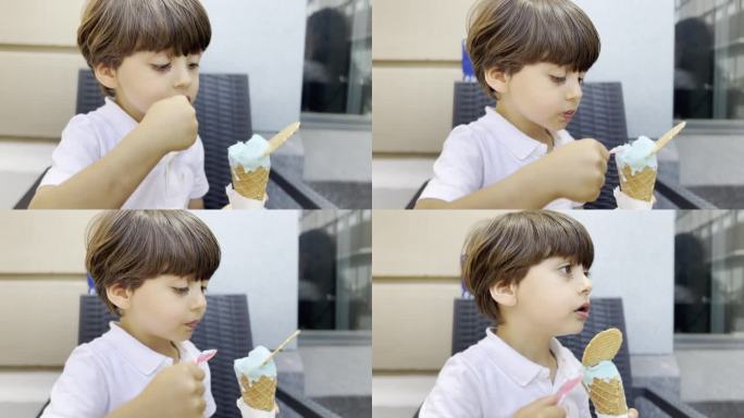 男孩坐在路边的椅子上在户外品尝冰淇淋——城市的乐趣