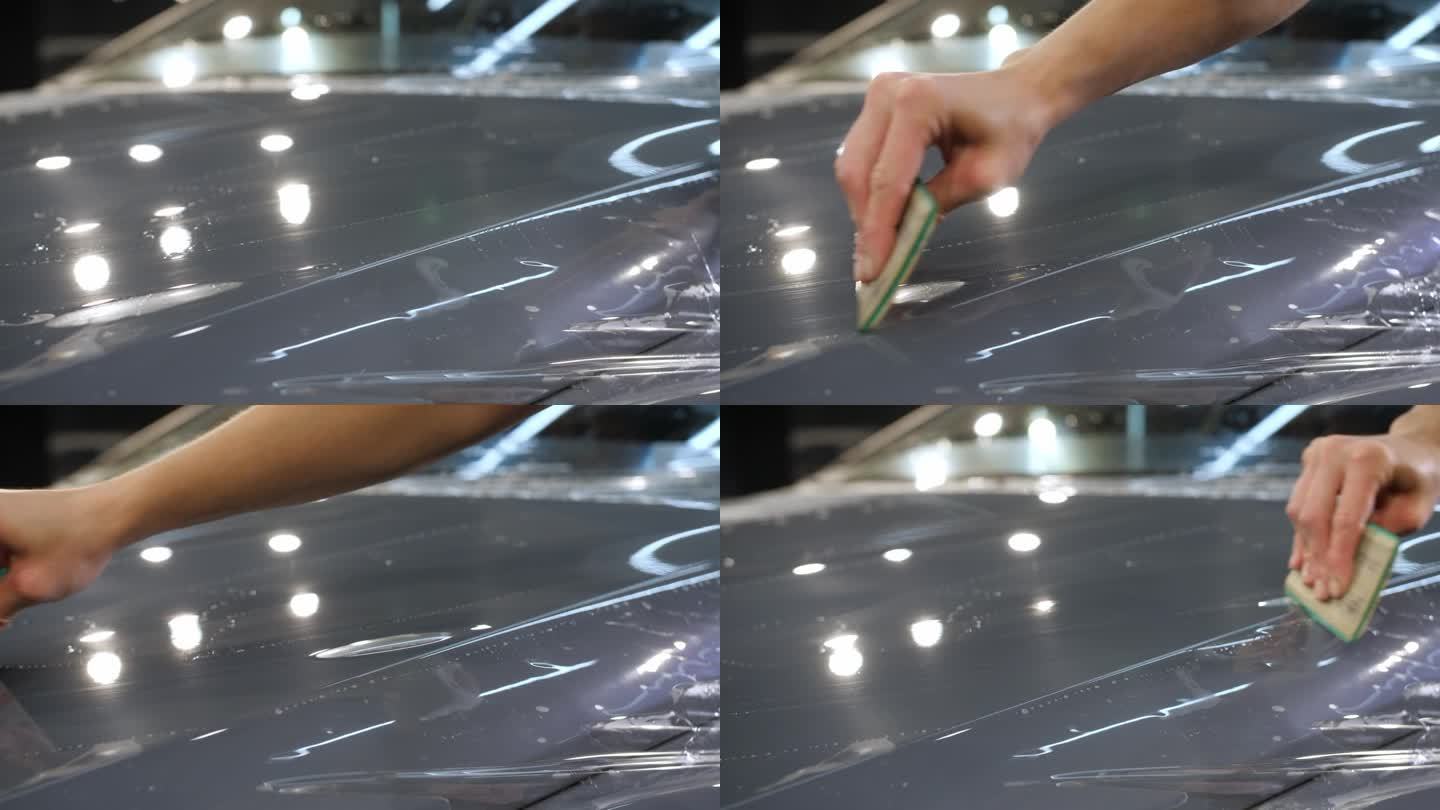 一只手拿着塑料刮板在新车上涂上了一层防砾石保护膜