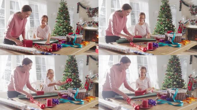 母亲和女儿在家里包装圣诞礼物的肖像。可爱的小女孩为送给家人的礼品盒挑选装饰品。充满爱和分享的节日