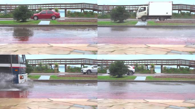 车辆在被淹的道路上行驶，溅起水花，手持跟踪