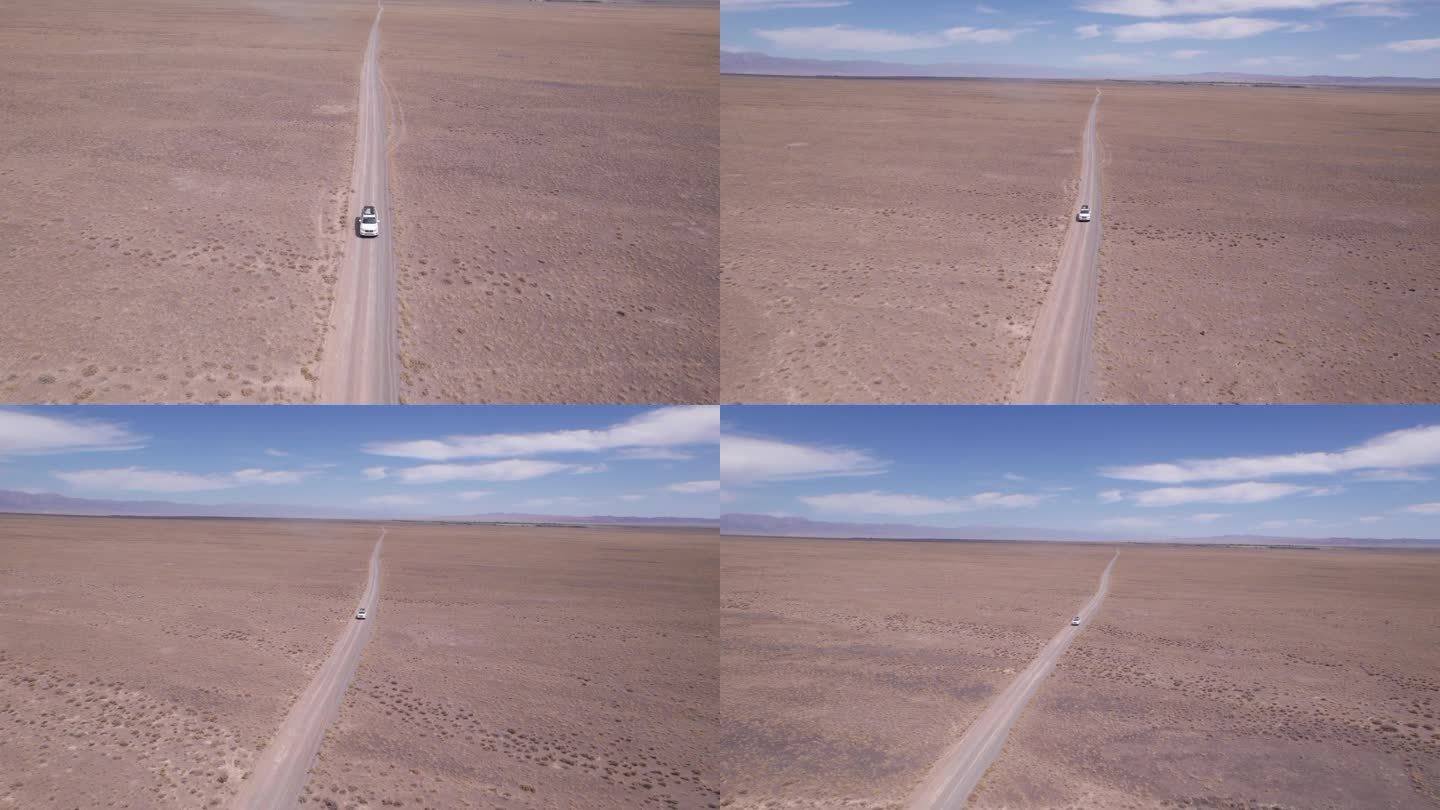 一辆白色SUV在尘土飞扬的路上疾驰。无人机
