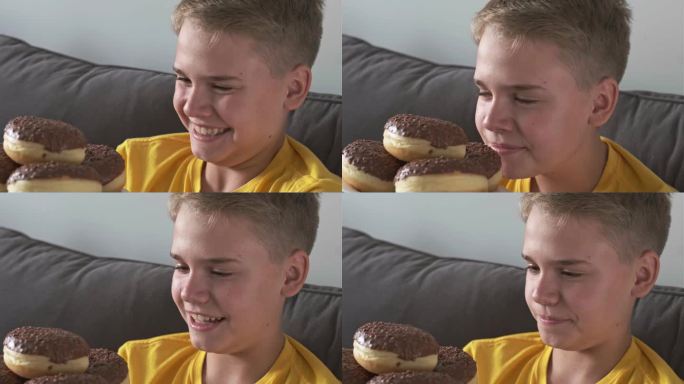 一个快乐的少年满怀期待地看着满满一盘巧克力甜甜圈。传递和不健康甜食的概念。