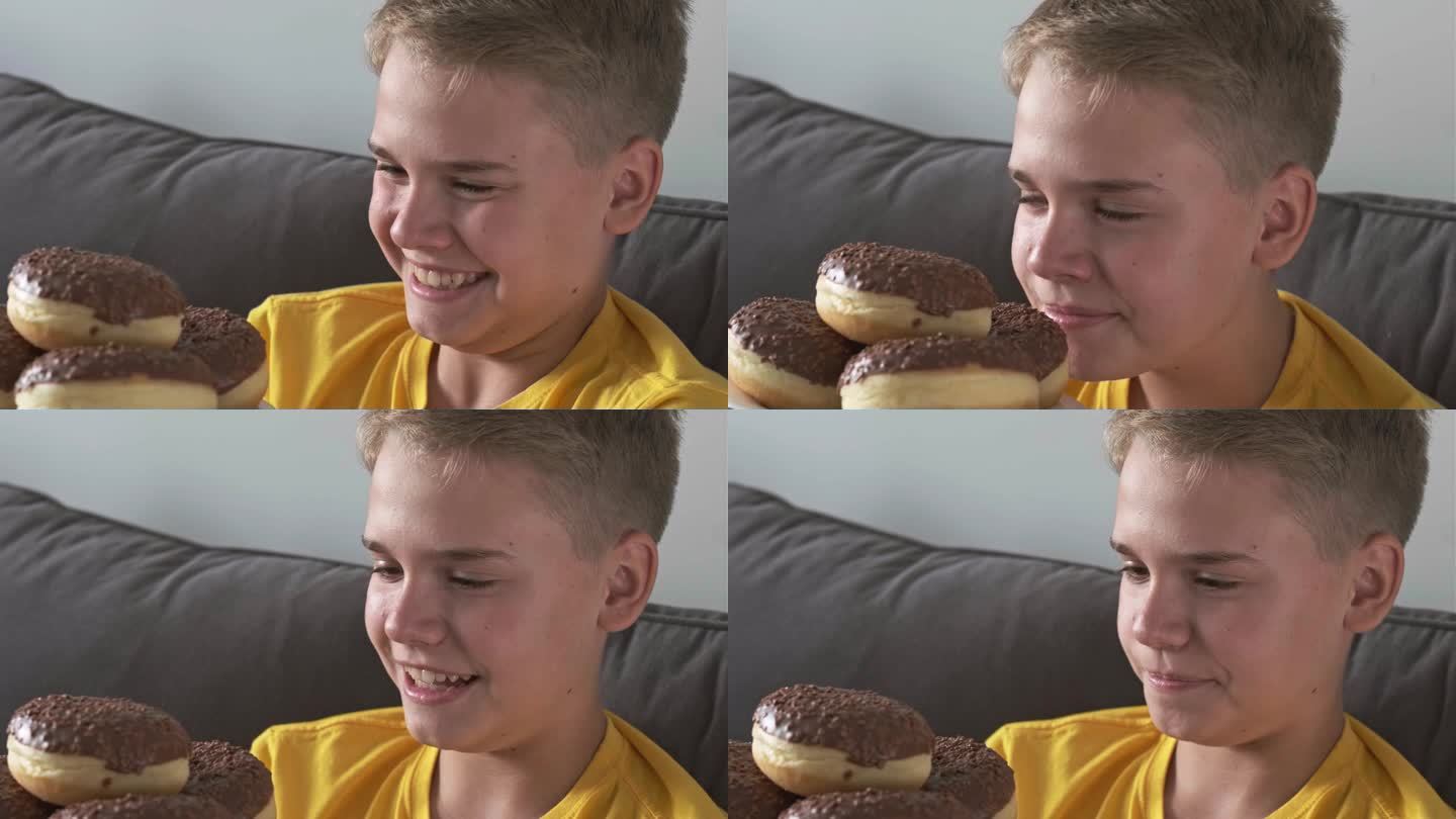 一个快乐的少年满怀期待地看着满满一盘巧克力甜甜圈。传递和不健康甜食的概念。