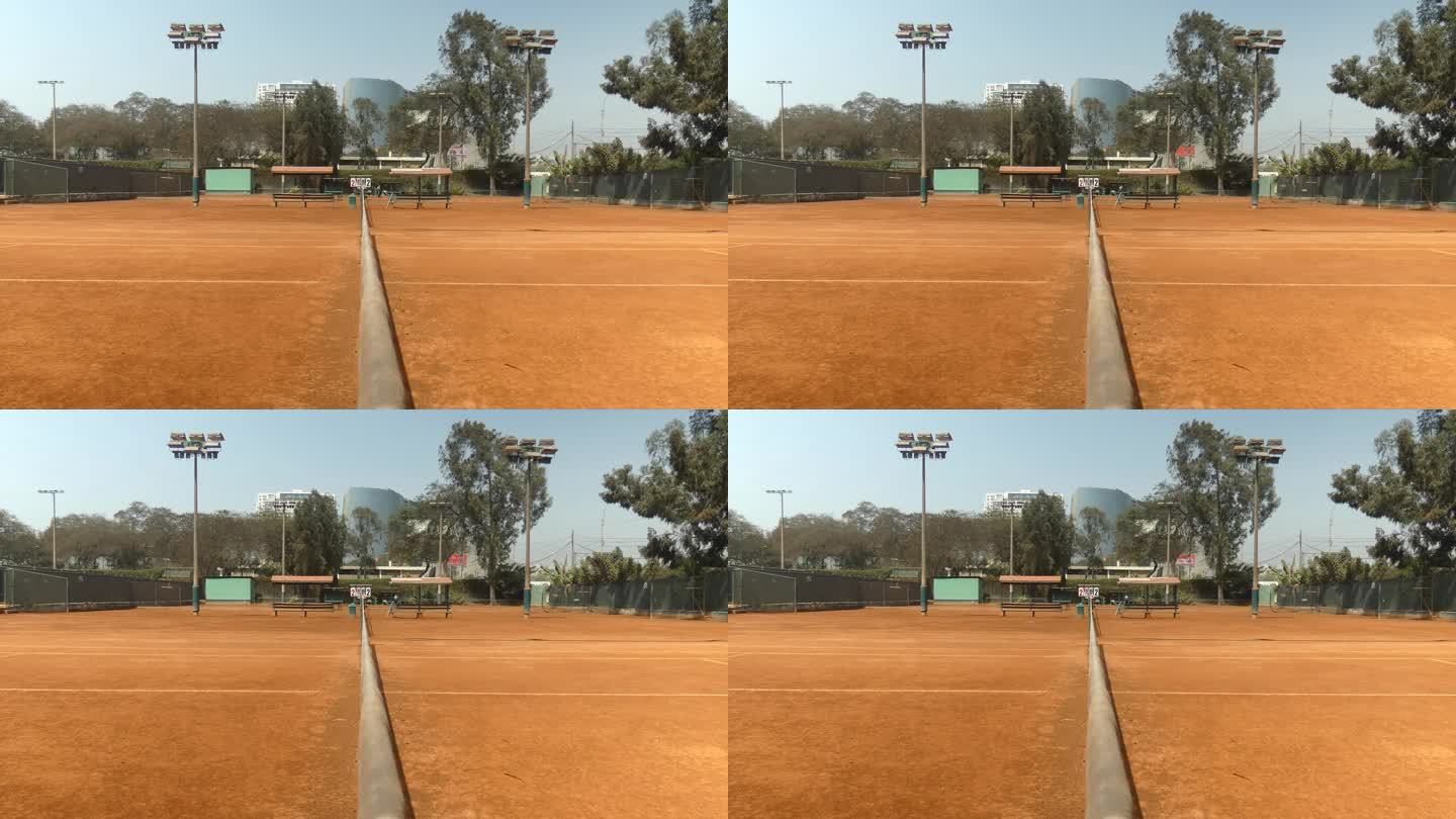 红土网球场的4k视频。由碎砖制成，所以呈红色。摄像机位于球场中央的网顶。