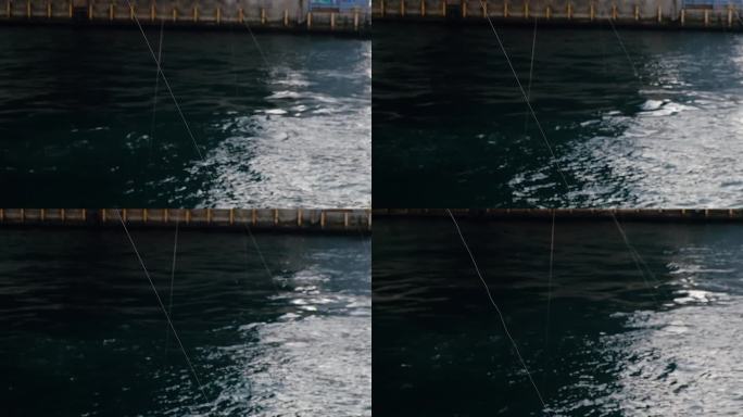 鱼线在黑暗的海水上盘旋。下桥。钓鱼运动概念