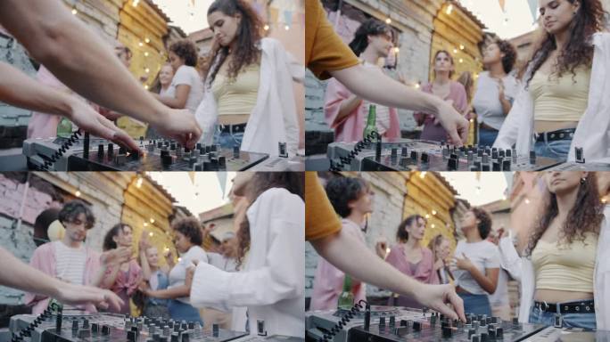 一群朋友在户外咖啡馆跳舞时，DJ手用现代设备混合音乐的特写