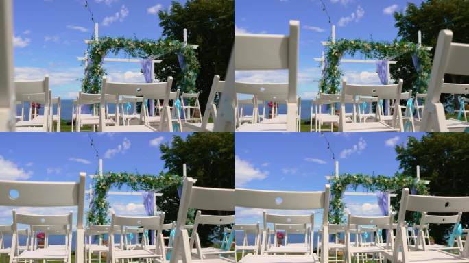 婚礼装饰沙滩设置海滨花拱与座位舞台，为婚礼司仪