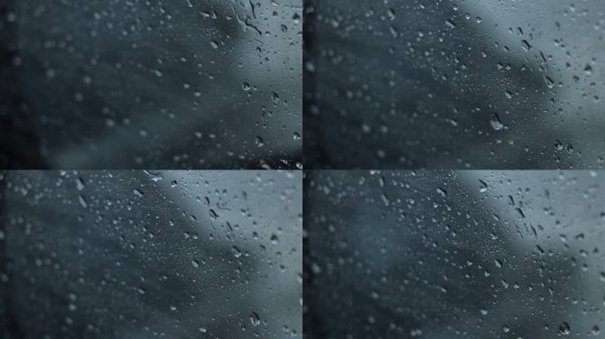 雨点落在高速行驶的汽车上，从里面看窗户，雨打在窗户上
