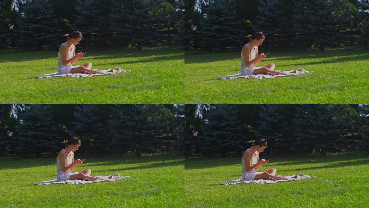 在绿草地上休息的女人。读书和放松