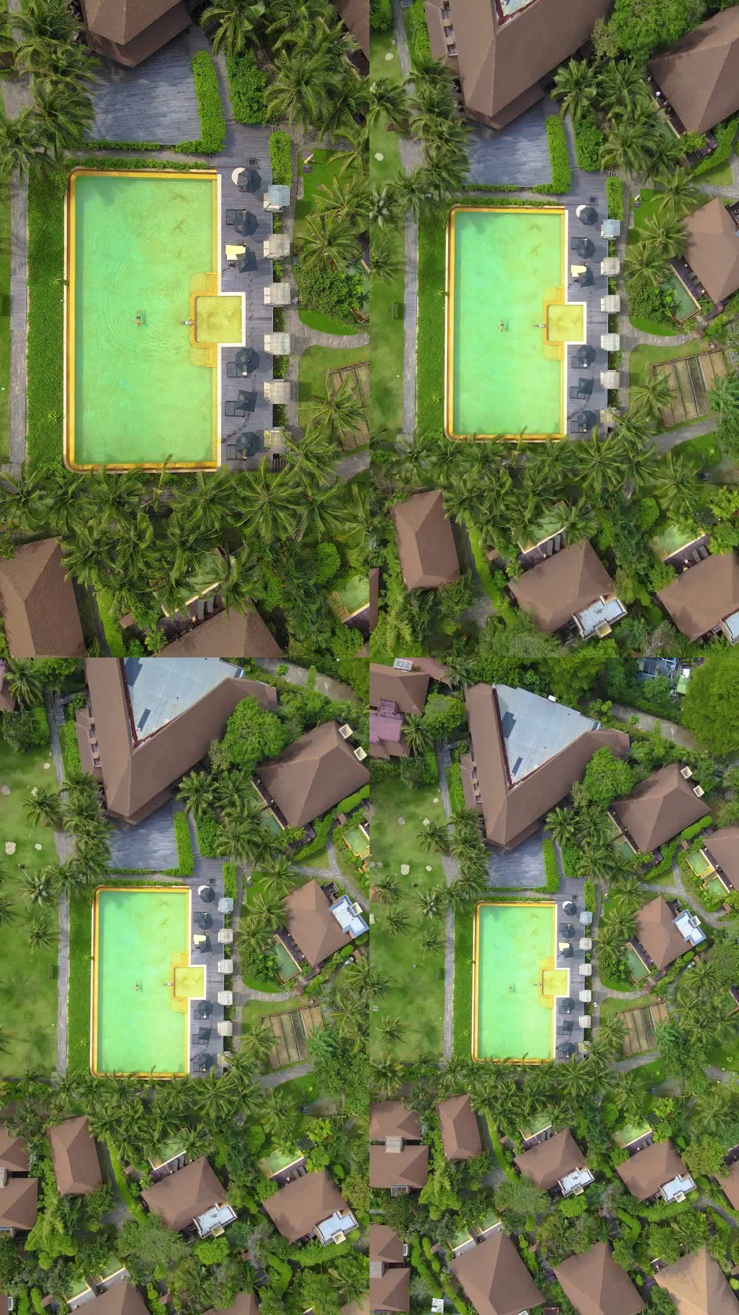 俯瞰一对夫妇在泰国古德岛的游泳池