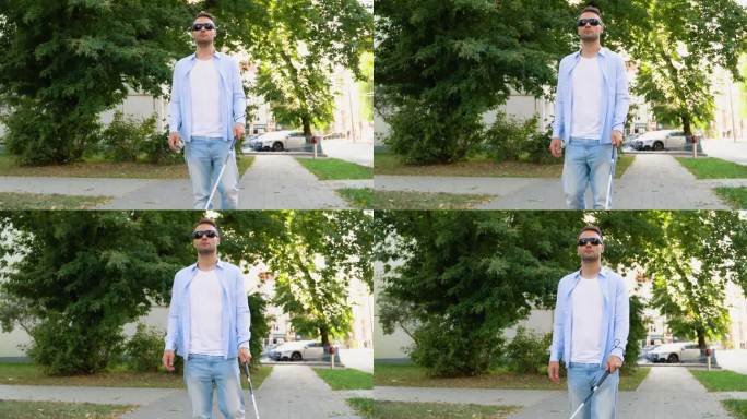 一个盲人走在街上。拄着拐杖的视障男子