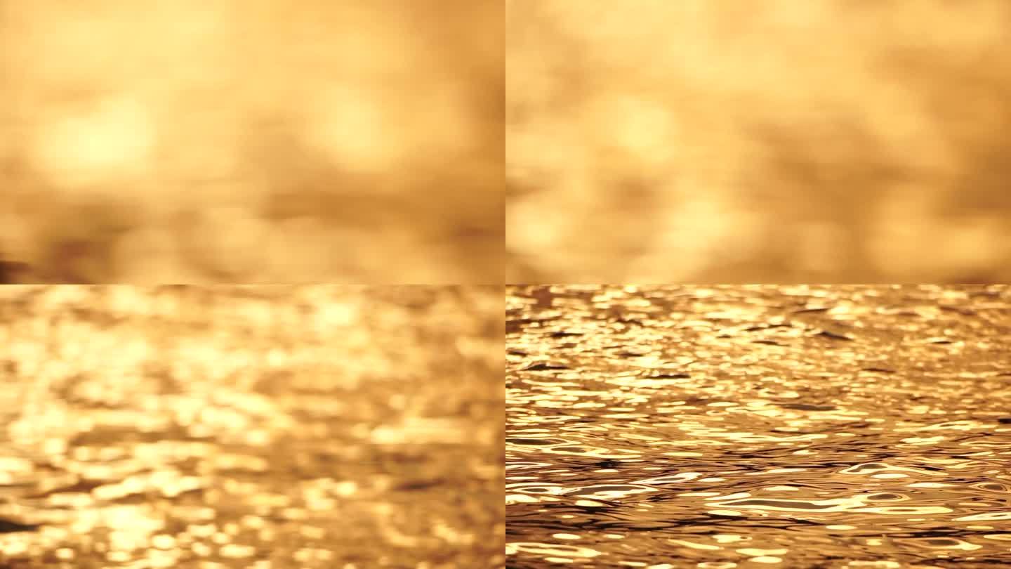 模糊的金色大海在日落与移动焦点和散景效果。太阳反射着波光，照亮了金色的大海。假日休闲概念。抽象航海夏