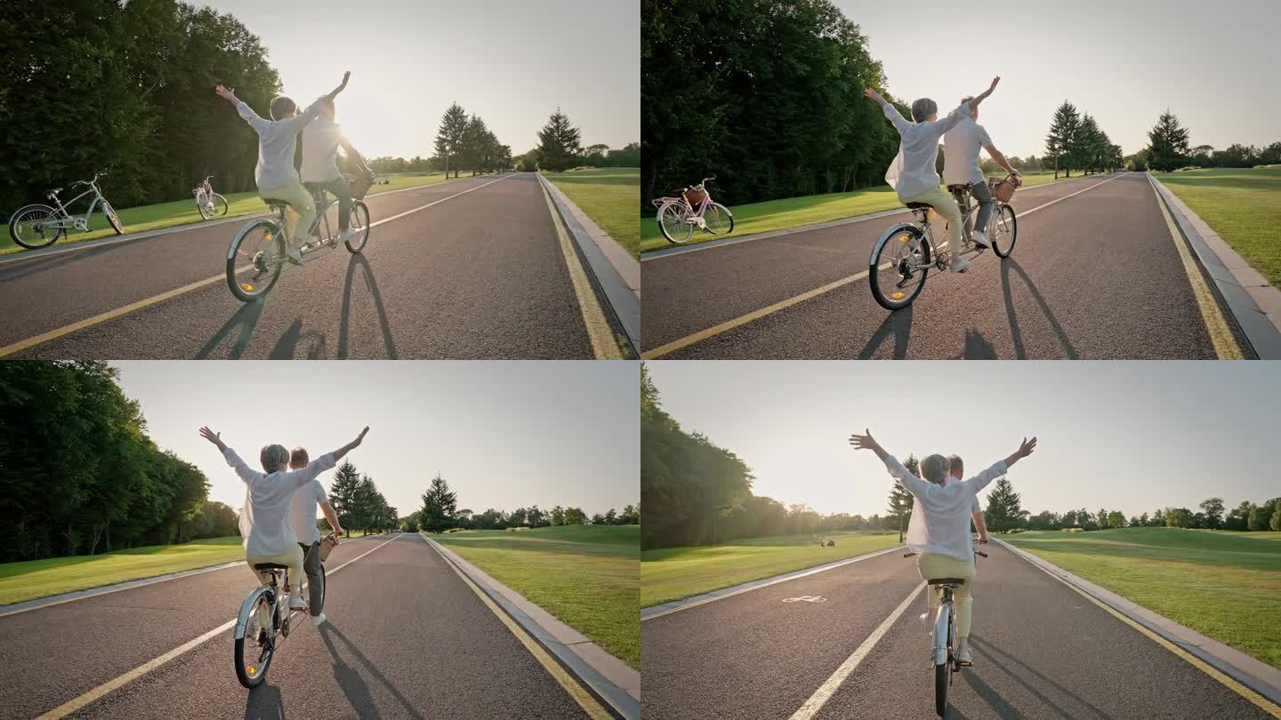 一对老夫妇骑着双轮自行车在自行车道上旅行