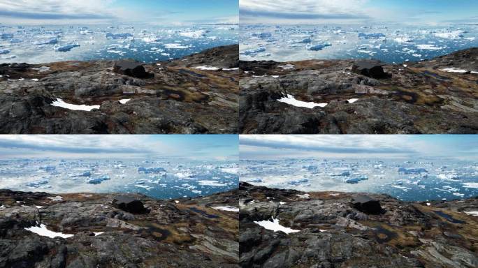 位于格陵兰岛岩石海岸的偏远科学家站，背景是冰山，鸟瞰图