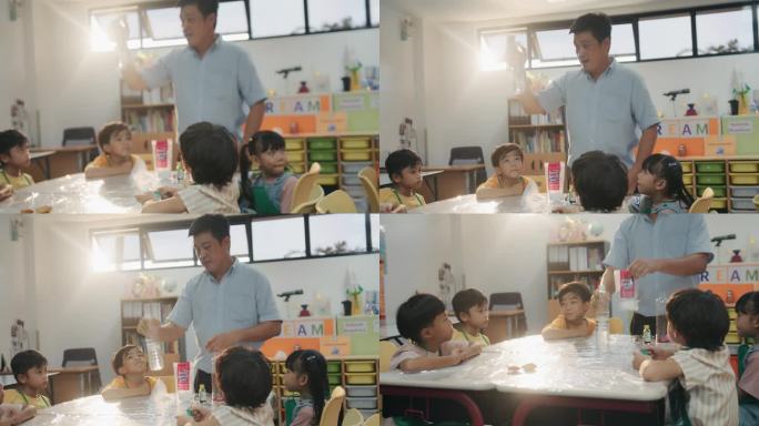 一位亚洲男教师在科学课上给小学生们推荐科学实验设备。