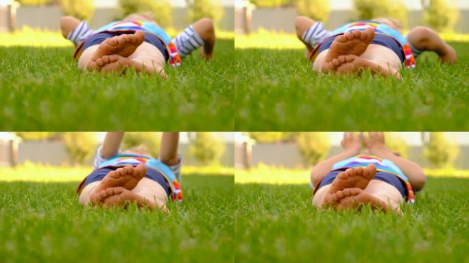 孩子的脚踩在公园的草地上。有选择性的重点。