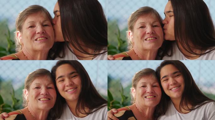 爱与情感，亚洲不同的孙女拥抱白种人的祖母脸颊对脸颊的代际肖像