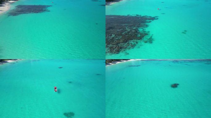 在圣埃斯皮里图岛的奥利港，一架无人驾驶飞机和一艘红船飞过令人难以置信的蓝色水域。瓦努阿图偏远的原始地