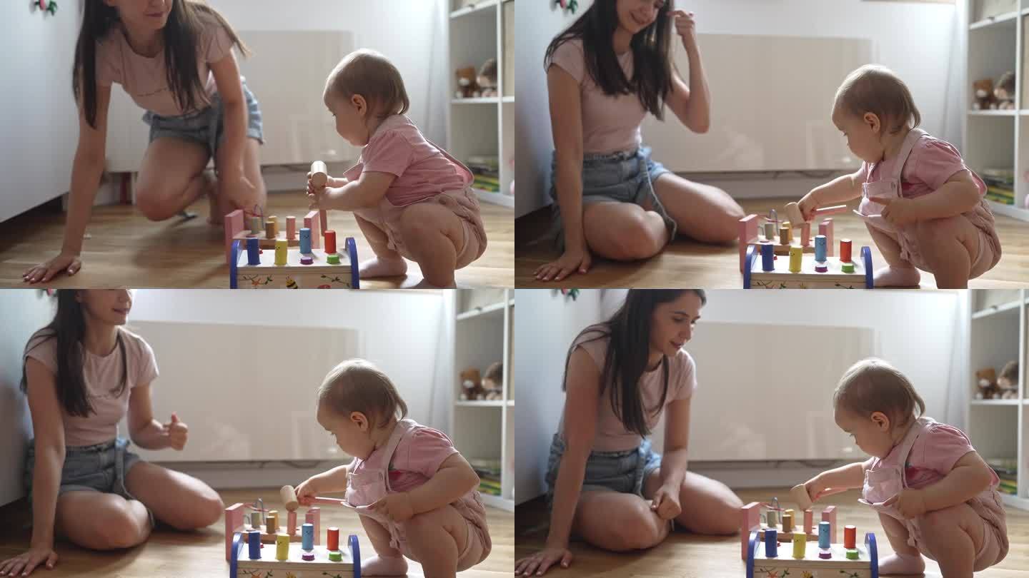 可爱的婴儿在玩木锤积木玩具