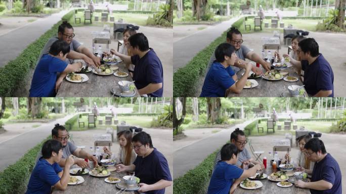 四个大学生在大学食堂外吃饭。