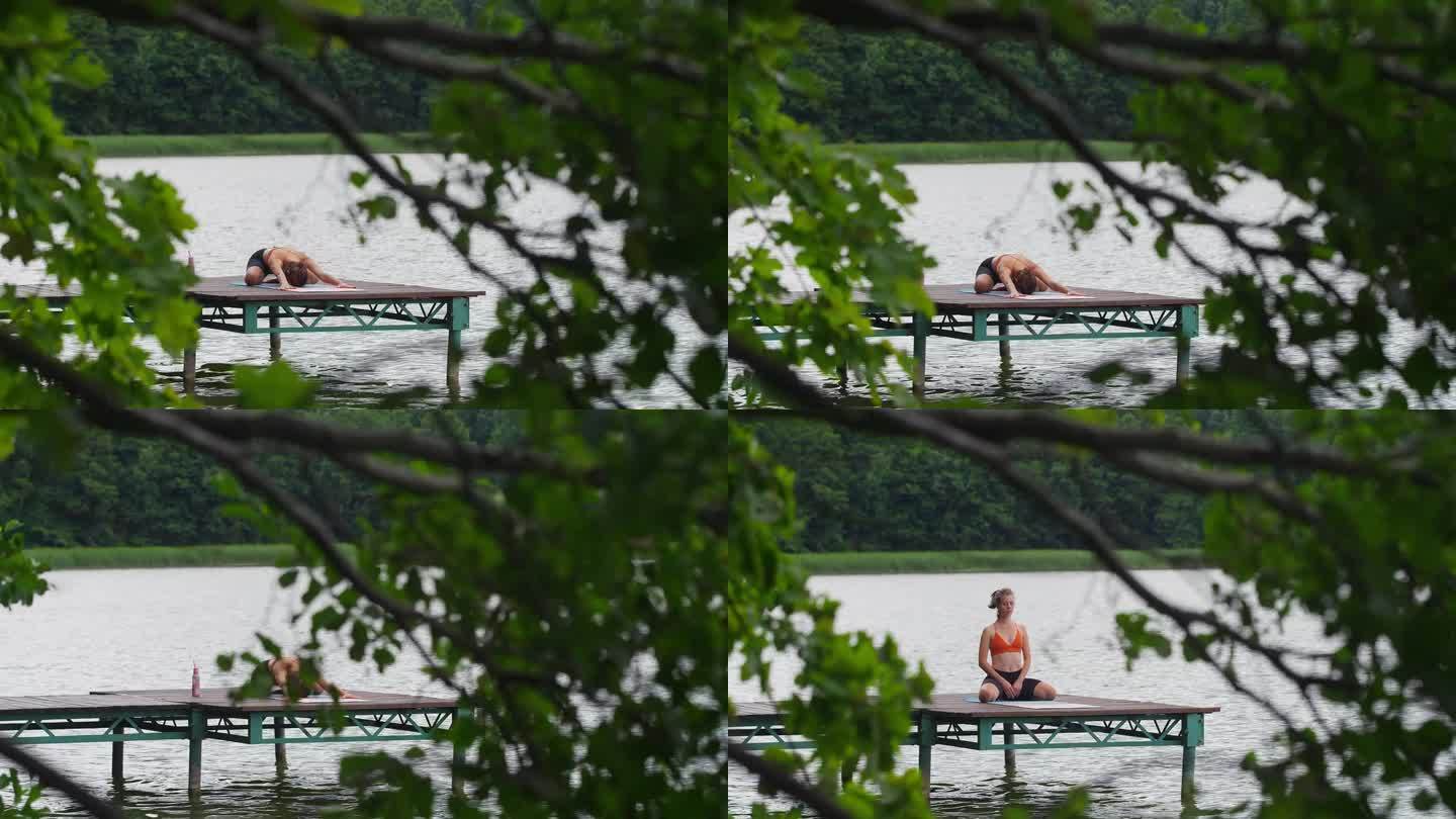 在湖边运动的女人。在木码头上做瑜伽伸展运动