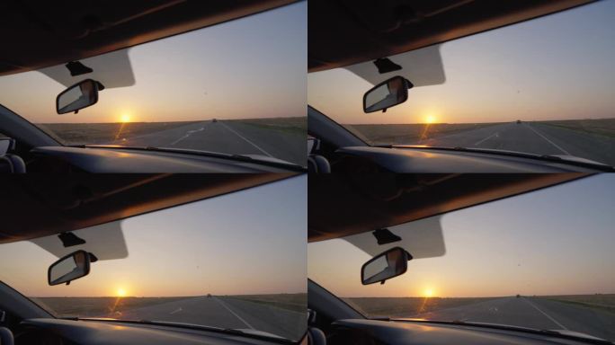 从高速公路上驾驶的汽车内看。在道路上行驶的挡风玻璃车辆