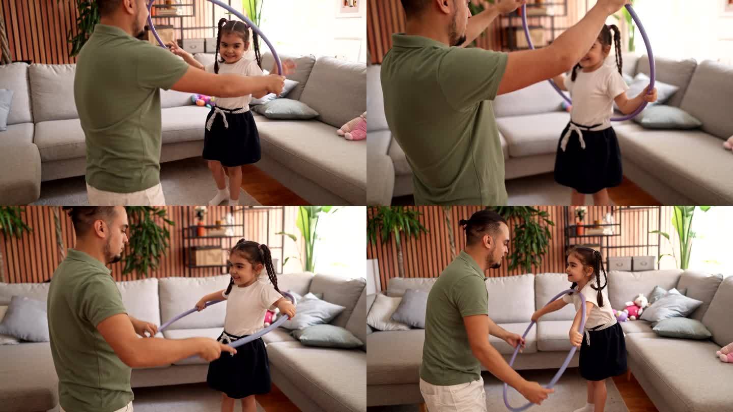 父亲和女儿在家里玩呼啦圈
