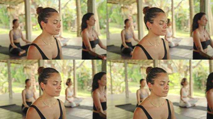 女性在健身课上的瑜伽和冥想。苗条运动员女孩的健康能量概念。女性瑜伽修行者坐在绿色工作室进行身体健康护