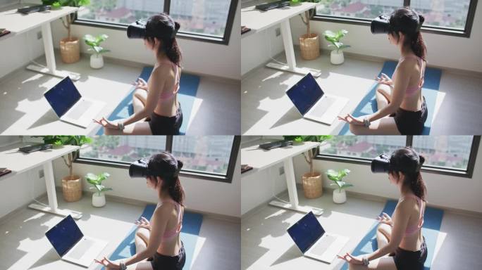 亚洲运动女性做瑜伽虚拟现实练习