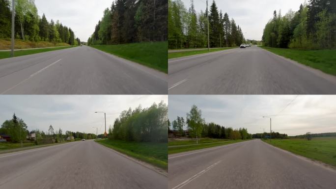 沿着一条美丽的芬兰公路快速行驶，两边都是绿色的森林