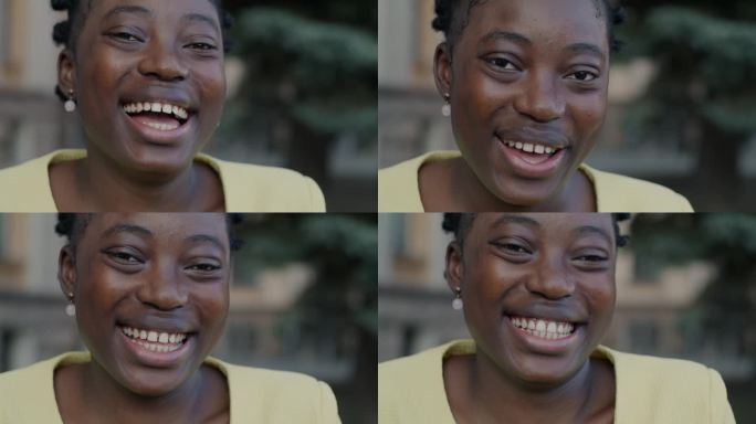 特写慢动作肖像欣喜若狂的非裔美国妇女笑着在城市的街道上玩