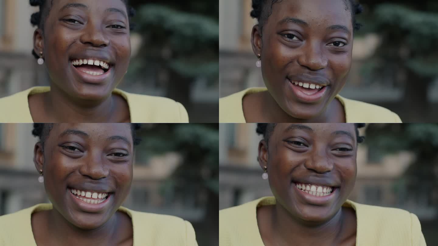 特写慢动作肖像欣喜若狂的非裔美国妇女笑着在城市的街道上玩