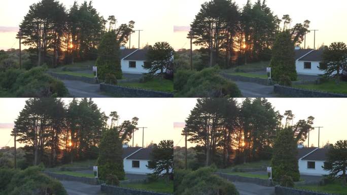 爱尔兰，克拉林桥，火红的橙色夕阳背后，右边是白色的房产。放大