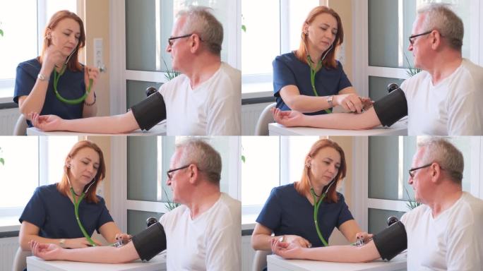 女心脏病专家在医生办公室测量一位老年病人的血压。